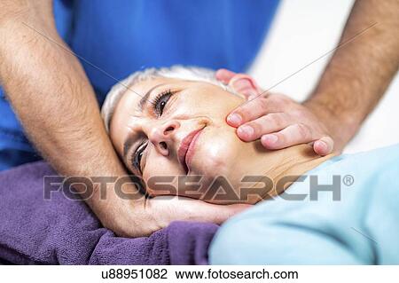 Physical therapist stretching senior woman's neck View Large Photo Image Stock Image - Physical therapist stretching senior woman's neck. Fotosearch