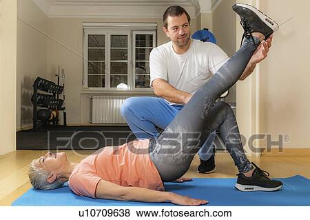 Physical therapist stretching senior woman View Large Photo Image Stock Photo - Physical therapist stretching senior woman. Fotosearch