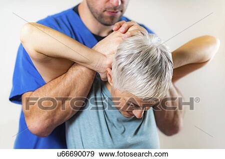 Stock Photo - Physical therapist stretching senior woman's neck. Fotosearch