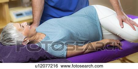 Physical therapist stretching senior woman View Large Photo Image Stock Photograph - Physical therapist stretching senior woman. Fotosearch