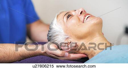 Physical therapist stretching senior woman's neck View Large Photo Image Stock Photography - Physical therapist stretching senior woman's neck. Fotosearch