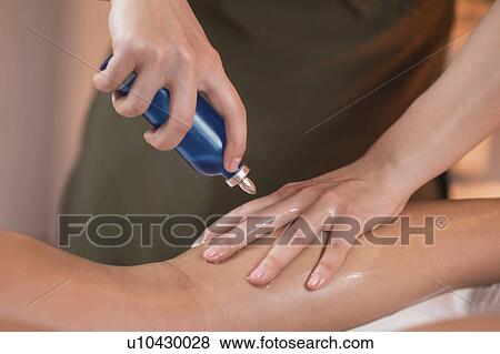 Physiotherapist applying massage oil View Large Photo Image Stock Photo - Physiotherapist applying massage oil. Fotosearch
