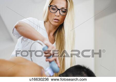Physiotherapist using ultrasound View Large Photo Image Stock Photograph - Physiotherapist using ultrasound. Fotosearch