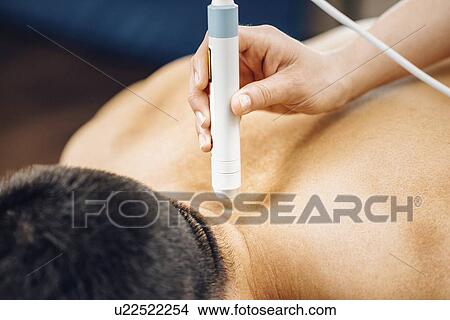 Picture - Physiotherapy laser treatment. Fotosearch
