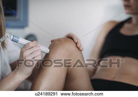 Stock Image - Physiotherapy laser treatment. Fotosearch