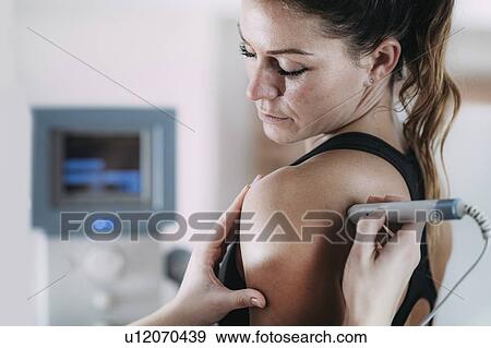 Stock Photo - Physiotherapy laser treatment. Fotosearch