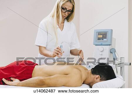 Stock Photo - Physiotherapy laser treatment. Fotosearch