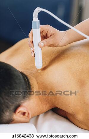 Stock Photo - Physiotherapy laser treatment. Fotosearch