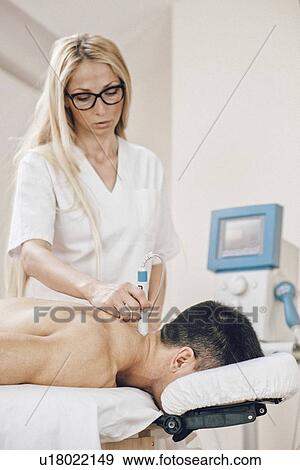 Stock Photo - Physiotherapy laser treatment. Fotosearch