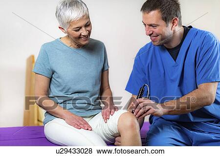 Stock Photo - Physiotherapy laser treatment. Fotosearch
