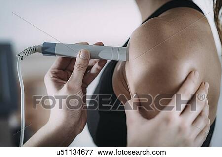 Stock Photo - Physiotherapy laser treatment. Fotosearch