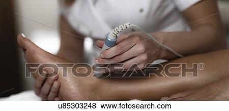 Stock Photo - Physiotherapy laser treatment. Fotosearch