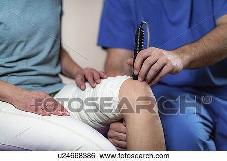 Stock Photograph - Physiotherapy laser treatment. Fotosearch