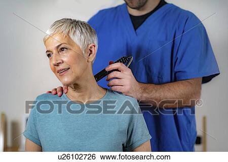 Stock Photograph - Physiotherapy laser treatment. Fotosearch