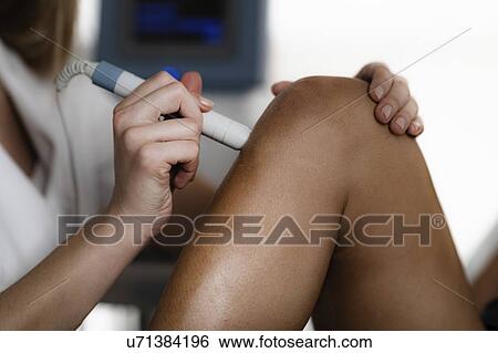 Stock Photograph - Physiotherapy laser treatment. Fotosearch