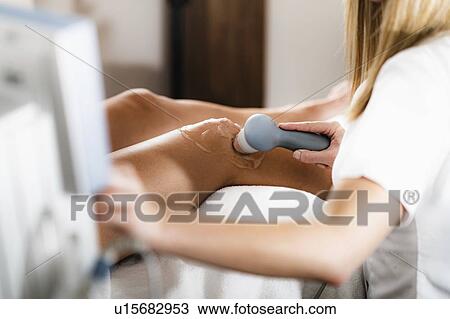 Stock Image - Physiotherapy ultrasound treatment. Fotosearch