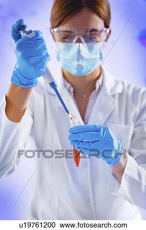Stock Image - Pipetting sample. Fotosearch
