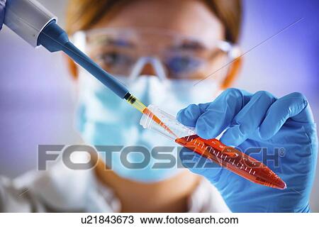 Stock Image - Pipetting sample. Fotosearch