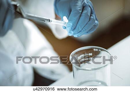 Pipetting sample View Large Photo Image Stock Photograph - Pipetting sample. Fotosearch