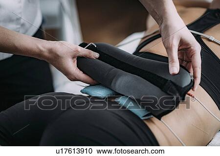 Placing TENS electrodes on back View Large Photo Image Stock Image - Placing TENS electrodes on back. Fotosearch