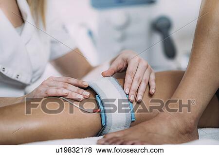 Placing TENS electrodes on knee View Large Photo Image Stock Photo - Placing TENS electrodes on knee. Fotosearch