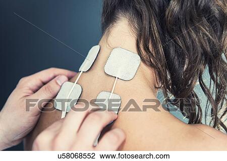 Placing TENS electrodes on neck View Large Photo Image Stock Image - Placing TENS electrodes on neck. Fotosearch