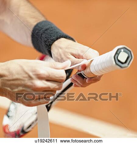 Player putting new grip tape on tennis racket View Large Photo Image Stock Image - Player putting new grip tape on tennis racket. Fotosearch
