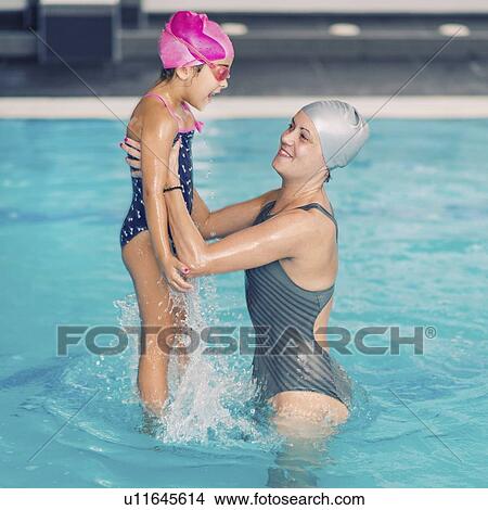 Playing in swimming pool View Large Photo Image Picture - Playing in swimming pool. Fotosearch