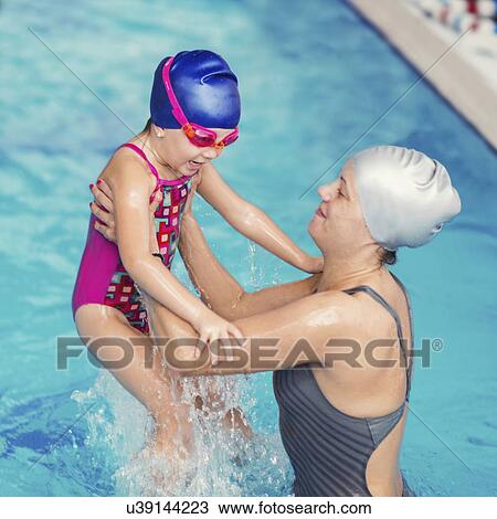 Stock Image - Playing in swimming pool. Fotosearch