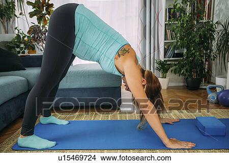Pregnant woman doing yoga at home View Large Photo Image Picture - Pregnant woman doing yoga at home. Fotosearch