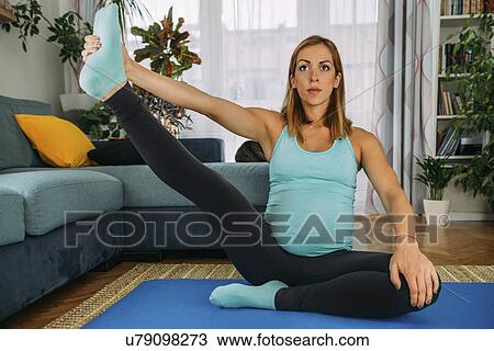 Pregnant woman doing yoga at home View Large Photo Image Stock Image - Pregnant woman doing yoga at home. Fotosearch