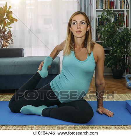 Pregnant woman doing yoga at home View Large Photo Image Stock Photography - Pregnant woman doing yoga at home. Fotosearch