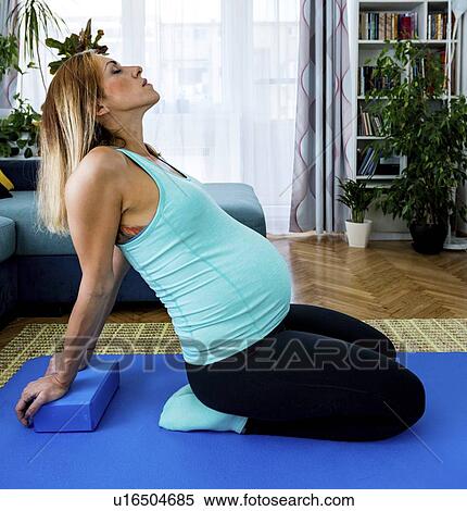 Pregnant woman doing yoga at home View Large Photo Image Stock Photography - Pregnant woman doing yoga at home. Fotosearch