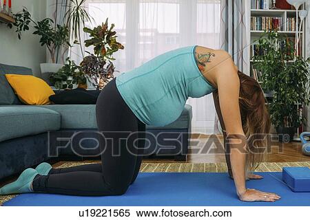 Pregnant woman doing yoga at home View Large Photo Image Stock Photography - Pregnant woman doing yoga at home. Fotosearch