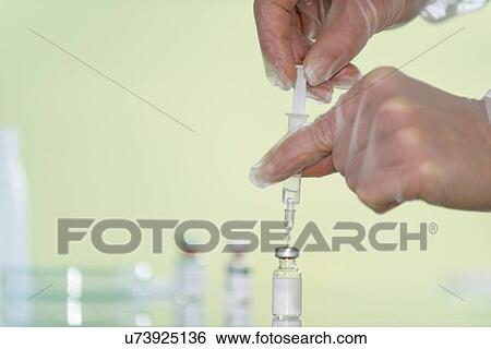 Stock Photograph - Preparing vaccine. Fotosearch