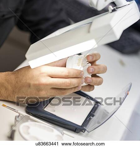 Stock Image - Prosthetic dentistry technician at work. Fotosearch