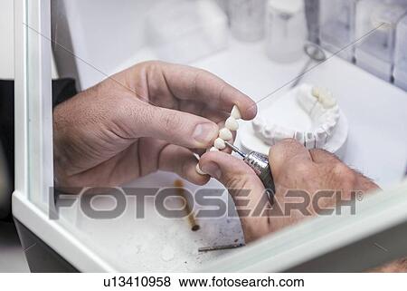 Stock Photo - Prosthetic dentistry technician at work. Fotosearch