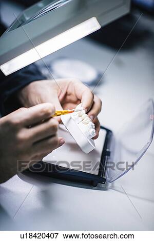 Stock Photo - Prosthetic dentistry technician at work. Fotosearch