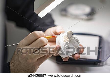 Stock Photo - Prosthetic dentistry technician at work. Fotosearch