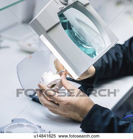 Stock Photography - Prosthetic dentistry technician at work. Fotosearch