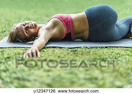 Stock Photograph - Reclining spinal twist position. Fotosearch
