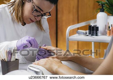 Removing fingernail cuticles View Large Photo Image Stock Photo - Removing fingernail cuticles. Fotosearch