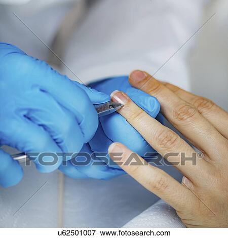 Stock Photo - Removing fingernail cuticles. Fotosearch