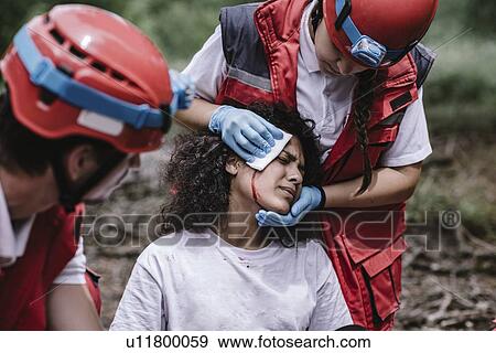 Rescue team treating injuries in the field View Large Photo Image Stock Photo - Rescue team treating injuries in the field. Fotosearch
