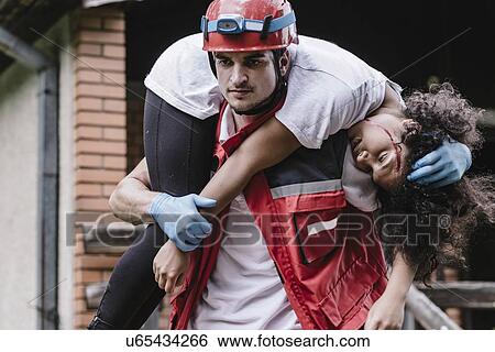 Rescue worker carrying woman View Large Photo Image Stock Photograph - Rescue worker carrying woman. Fotosearch