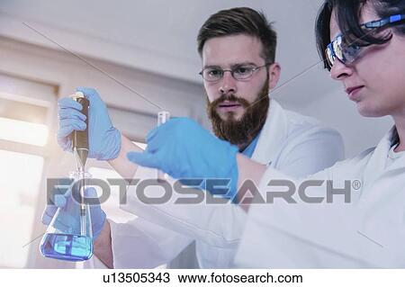 Researcher using micropipette View Large Photo Image Stock Image - Researcher using micropipette. Fotosearch
