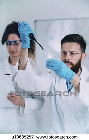 Researcher using micropipette View Large Photo Image Stock Photo - Researcher using micropipette. Fotosearch