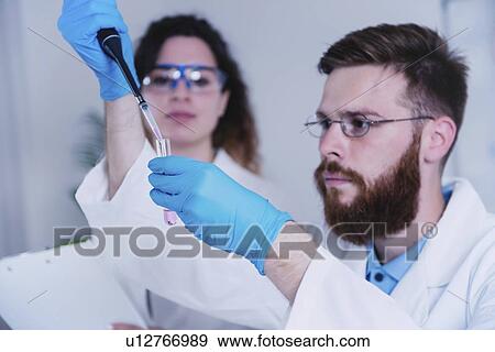 Researcher using micropipette View Large Photo Image Stock Photo - Researcher using micropipette. Fotosearch