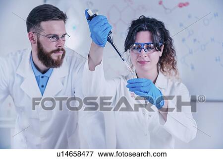 Researcher using micropipette View Large Photo Image Stock Photo - Researcher using micropipette. Fotosearch