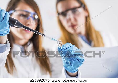 Researcher using micropipette View Large Photo Image Stock Photography - Researcher using micropipette. Fotosearch